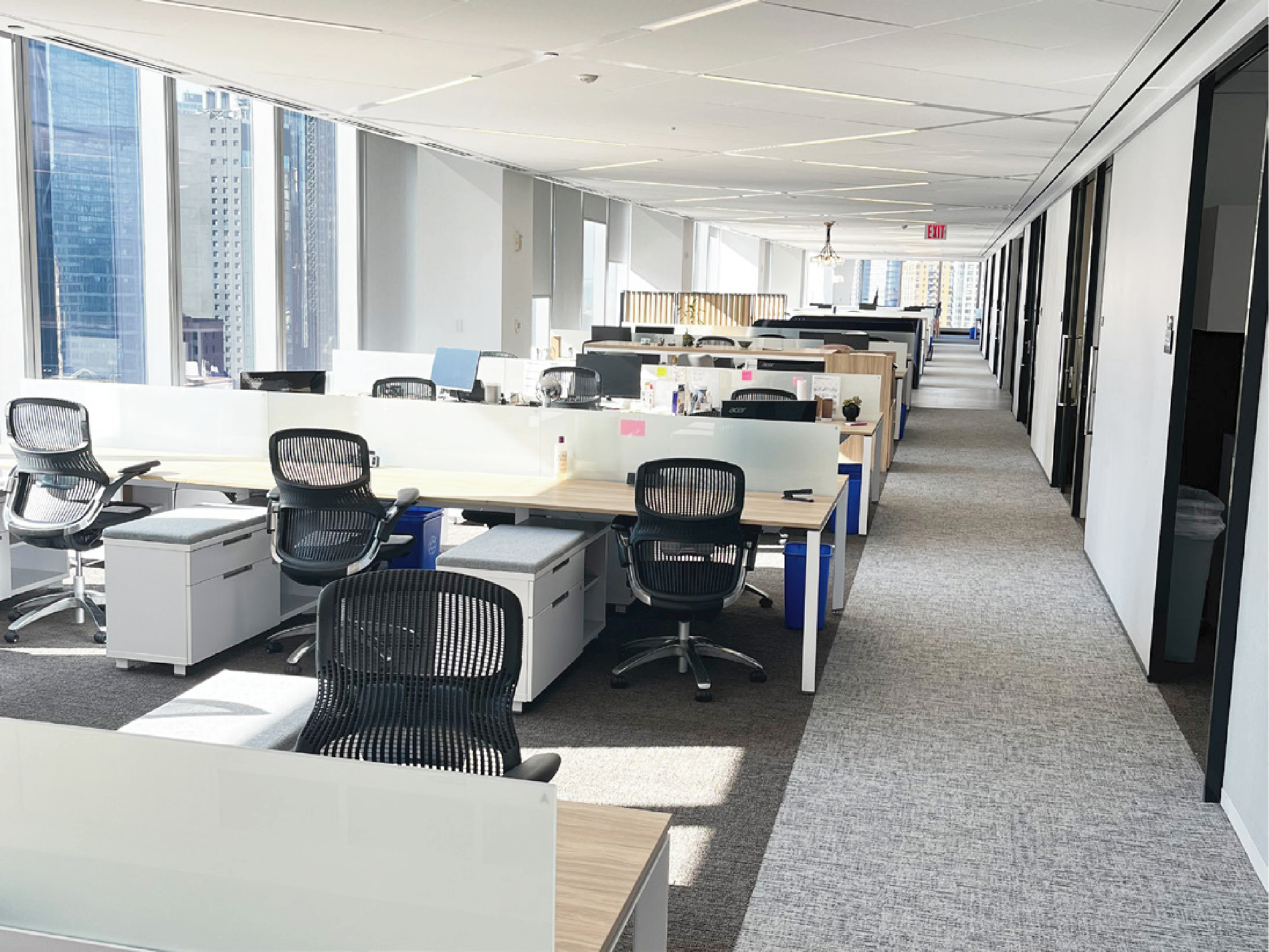 Contemporary office interior with open work areas, natural light, and comfortable professional furnishings