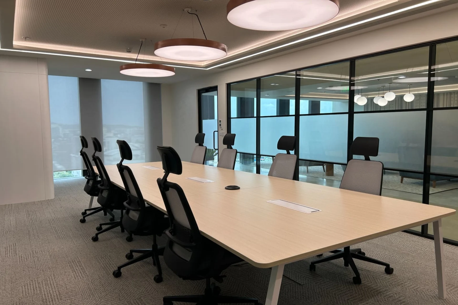 Bright furnished private office with desks and seating arranged for a professional team